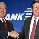 MCI-WorldCom CEO Donald Cosgrove (left) and Bank One-Chase Manhattan CEO Walter Courson celebrate their companies' historic $112 billion merger.